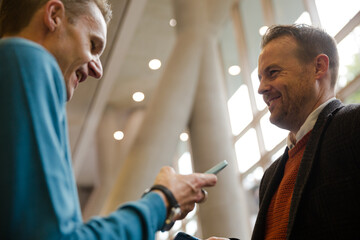 Businessmen talking during conference break