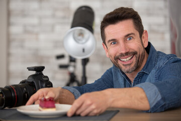 man with camera taking photos of fresh homemade pastries