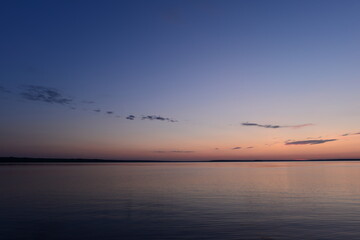 Blue clear sky in the summer twilight on the lake