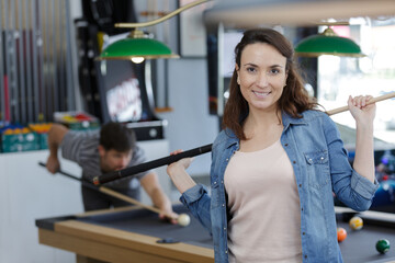 woman posing with a snooker stick