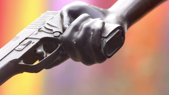 SLOWMO macro clip of statue holding a handgun