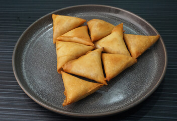 deep fried crispy yam taro spring roll samosa on dark grey wood background dim sum halal menu