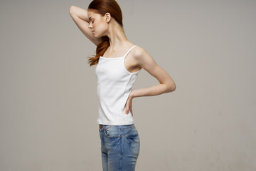 woman in white t-shirt chiropractic rheumatism health problems light background