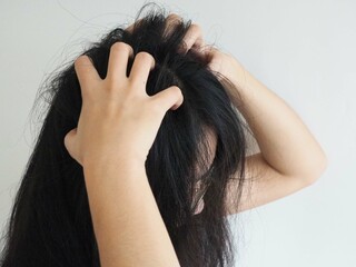 dandruff or lice in her hair woman and scratching her head for healthcare concept. 