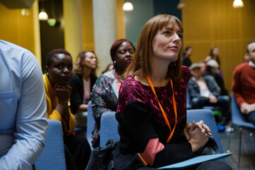 Attentive woman listening in conference audience