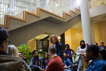 Speaker with microphone talking to audience