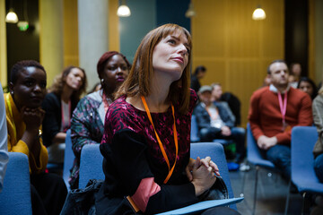 Attentive woman listening in conference audience