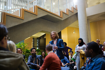 Speaker with microphone talking to audience