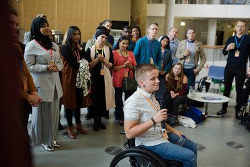 Female speaker in wheelchair talking to audience