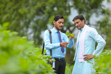 Naklejka premium Indian farmer Discussing with agronomist at Farm and collecting some information