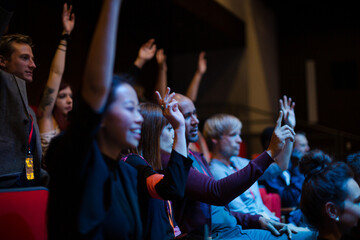 Enthusiastic audience clapping and cheering