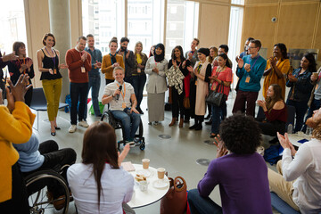 Female speaker in wheelchair talking to audience