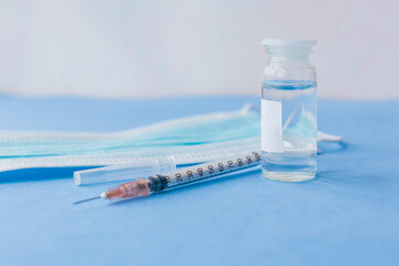 vaccine on a vial bottle and injection Syringe on a white table