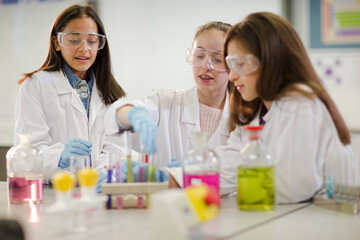 Girl students conducting scientific experiment in laboratory classroom