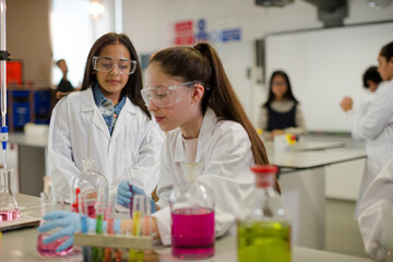 Girl students conducting scientific experiment in laboratory classroom