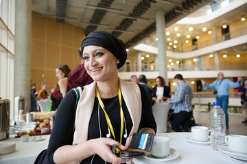 Smiling woman in hijab during conference break