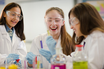 Girl students conducting scientific experiment in laboratory classroom