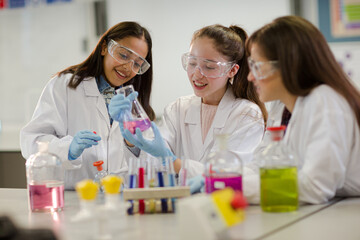 Girl students conducting scientific experiment in laboratory classroom