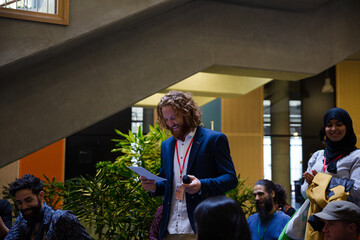 Speaker with microphone talking to audience