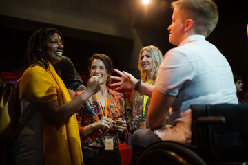 Speaker in wheelchair talking to conference audience