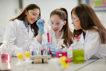 Girl students conducting scientific experiment in laboratory classroom