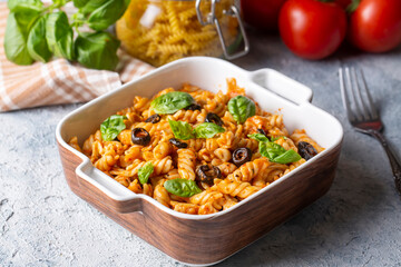 Basil leaves on pasta with arabiata sauce