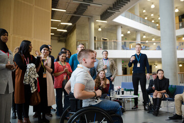 Female speaker in wheelchair talking to audience