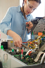 Girl student assembling computer in classroom