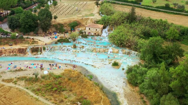 Aerial view of natural bath in tuscany, Italy. Hot cristalline water of spa. Saturnia natural spa with waterfalls and hot springs at Saturnia thermal baths, Grosseto,Tuscany. Beautiful panoramic shot.