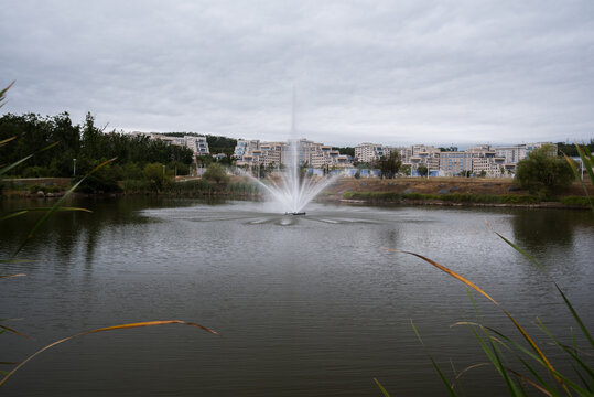 Vladivostok, Russia - August 20, 2021: Fountain in the center of an artificial lake on the campus of FEFU.