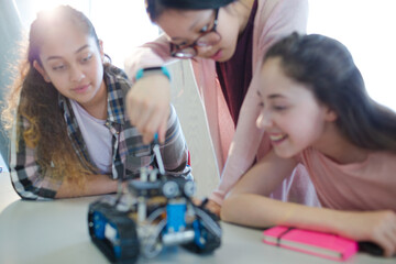 Students playing with robot in classroom