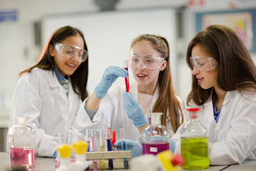 Girl students conducting scientific experiment in laboratory classroom