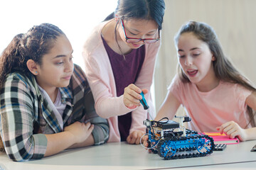 Fototapeta premium Students playing with robot in classroom