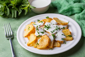 Traditional delicious Turkish foods, fried potatoes with yoghurt (Turkish name; Yogurt soslu patates kizartmasi)