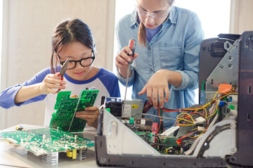 Girl students assembling computer in classroom © KOTO