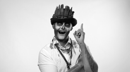 Creepy man with skeleton makeup in top-hat with feathers. Clever guy considering serious plan,...