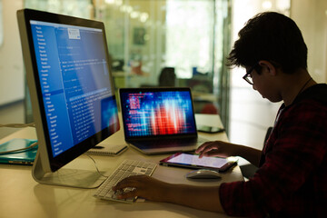 Student boy using computer at desk