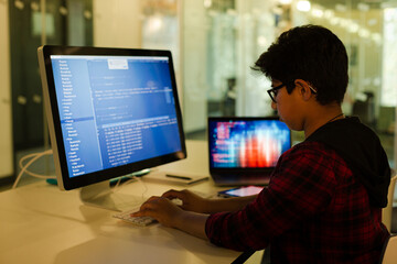 Student boy using computer at desk