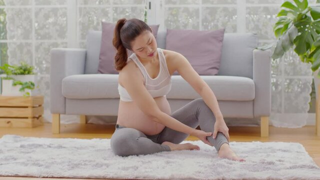 Pregnant Woman Touching And Massage On Calf Leg So Painful And Cramps Sudden,Pregnancy Of Woman Suffering From Calf Leg Cramps After Wake Up Stress On Her Muscle,Health Care Of Pregnancy Concept