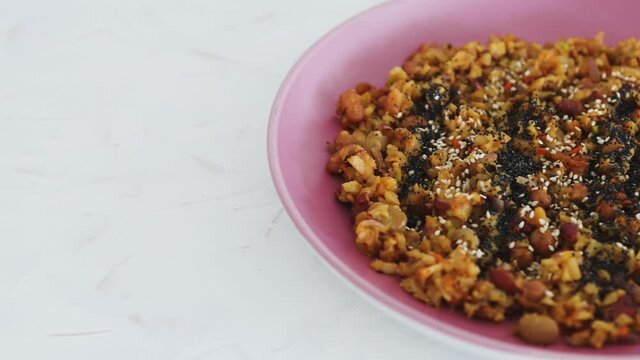 vegan sauteed potato beans and onion dish with seeds topping, healthy plant-based food