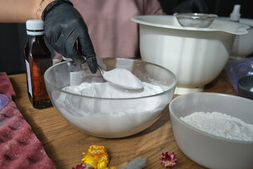handmade bath bombs process. Preparation of bath bombs. Ingredients and floral decor on a wooden vintage table.