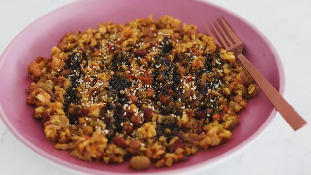 vegan sauteed potato beans and onion dish with seeds topping, healthy plant-based food