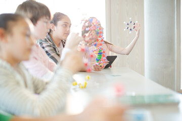 Portrait confident students holding molecular structures in laboratory classroom