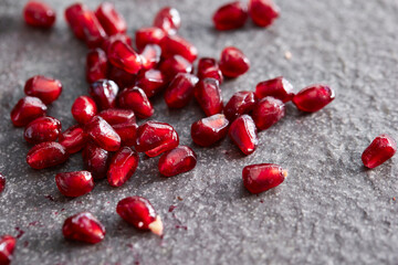 Fresh pomegranate seeds on marble