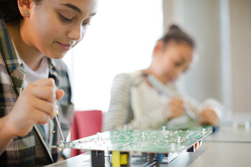 Students assembling computer in classroom