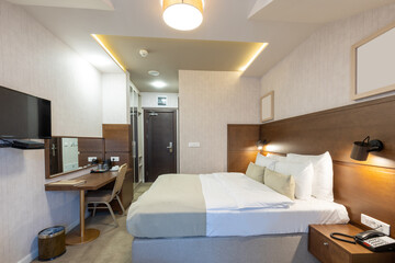 Naklejka na ściany i meble Empty hotel bedroom interior with master bed in the evening