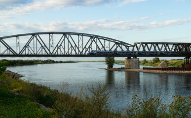 Fototapeta na wymiar A train passing through the Vistula River in Tczew 