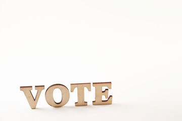'vote' wooden word on white background