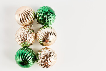 Christmas frame made of decor in the form of balls. green and gold Christmas decorations. space for text, top view