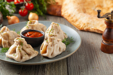 Traditional Georgian dumplings with meat. Khinkali. Served on a plate with traditional Georgian bread.